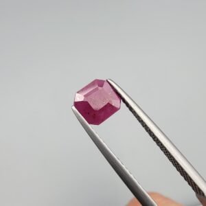 ​A 1.52 carat natural red Ruby (Yaqoot) from Kabul, Afghanistan, featuring an octagon step cut with rich saturation and natural internal characteristics, held in jeweler's tweezers.