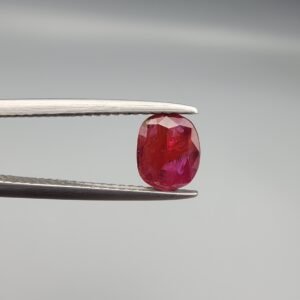 A 0.98 carat natural red Ruby (Yaqoot) from Kabul, Afghanistan, showing both front and back views to display its oval cut, rich saturation, and natural internal characteristics.