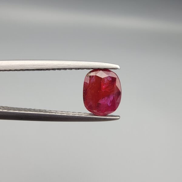 A 0.98 carat natural red Ruby (Yaqoot) from Kabul, Afghanistan, showing both front and back views to display its oval cut, rich saturation, and natural internal characteristics.
