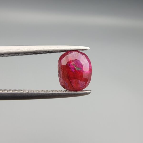 A 0.98 carat natural red Ruby (Yaqoot) from Kabul, Afghanistan, showing both front and back views to display its oval cut, rich saturation, and natural internal characteristics.