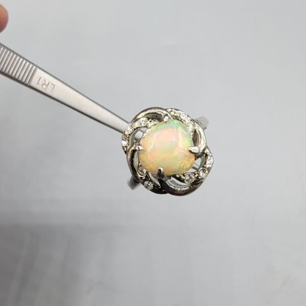 Natural Ethiopian Opal ring set in Turkish material steel, featuring a vibrant multicolor fire opal with decorative stones on a detailed metal design.