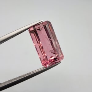 Natural pink tourmaline gemstone, 5.56 carat, emerald cut, Mozambique origin, vibrant rosy color.