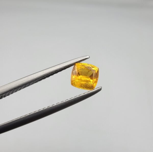 0.58 carat natural yellow sapphire gemstone (Pukhraj), cushion shape/cut, sourced from Madagascar. Available for sale in Karachi, Pakistan.