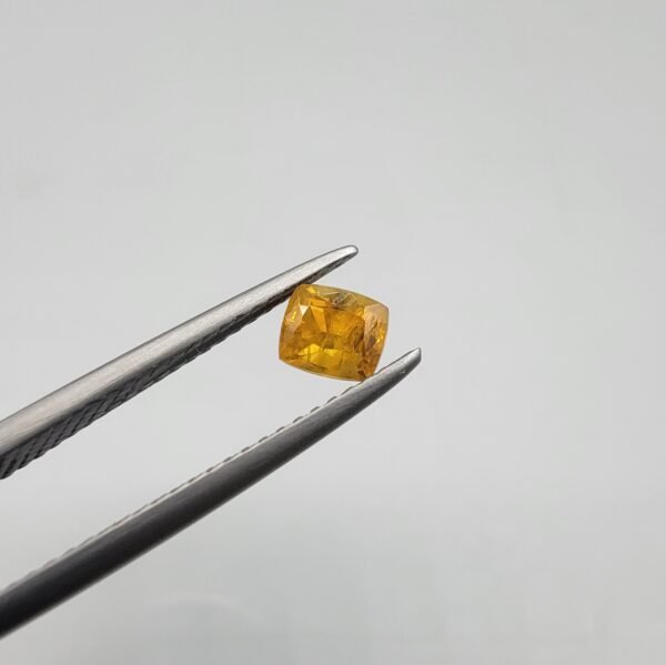 0.64 carat natural yellow sapphire gemstone (Pukhraj), square/cushion cut, sourced from Madagascar. Available for sale in Karachi, Pakistan.