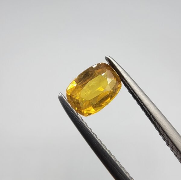 0.66 carat natural yellow sapphire gemstone (Pukhraj), oval cut, sourced from Madagascar. Available for sale in Karachi, Pakistan.