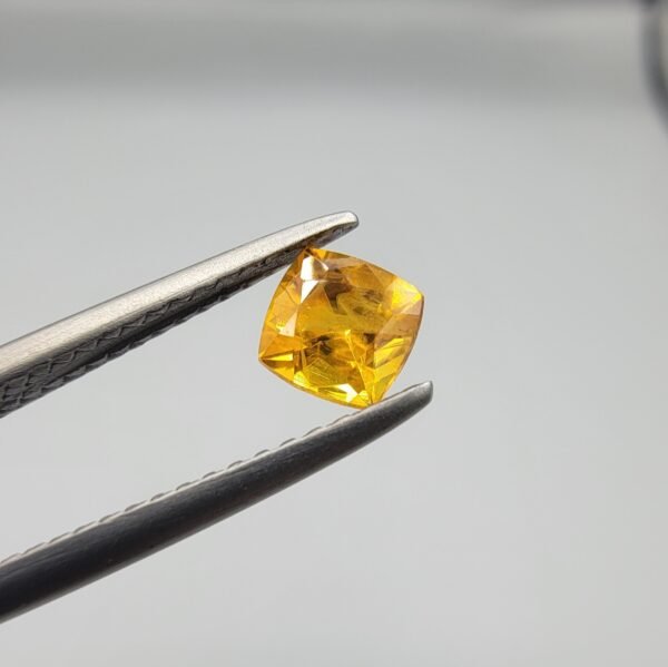 0.56 carat natural yellow sapphire gemstone (Pukhraj), square/cushion cut, sourced from Madagascar. Available for sale in Karachi, Pakistan.