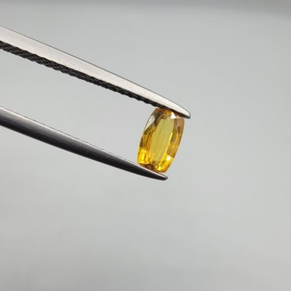 0.47 carat natural yellow sapphire gemstone (Pukhraj), oval cut, sourced from Madagascar. Available for sale in Karachi, Pakistan.