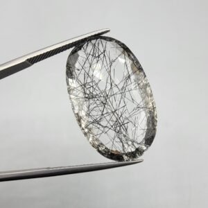 Natural rutilated quartz (Moh-E-Najaf) gemstone, 34 carat weight, oval cut, Iraq origin (Najaf), clear with black rutile inclusions.