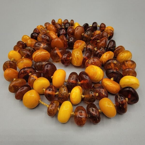 Natural Baltic Amber string featuring mixed yellow German amber beads and brown Russian amber beads, polished and naturally translucent, total weight 54 grams.