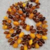 Natural Baltic Amber string featuring mixed yellow German amber beads and brown Russian amber beads, polished and naturally translucent, total weight 54 grams.