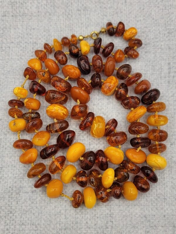 Natural Baltic Amber string featuring mixed yellow German amber beads and brown Russian amber beads, polished and naturally translucent, total weight 54 grams.