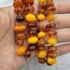 Natural Baltic Amber string featuring mixed yellow German amber beads and brown Russian amber beads, polished and naturally translucent, total weight 54 grams.