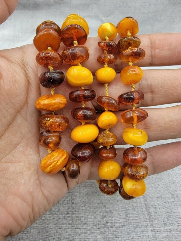 Natural Baltic Amber string featuring mixed yellow German amber beads and brown Russian amber beads, polished and naturally translucent, total weight 54 grams.