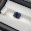Natural Blue Sapphire Neelam 4.61 carat from Afghanistan with deep blue color, emerald step cut and visible natural inclusions displayed on white cushion