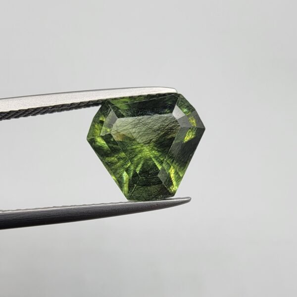 Natural rutilated peridot zabarjad 4.65 carat gemstone from Kohistan Valley Pakistan with visible rutile inclusions
