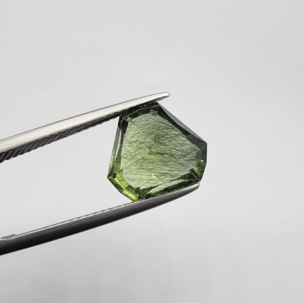 Natural rutilated peridot zabarjad 4.65 carat gemstone from Kohistan Valley Pakistan with visible rutile inclusions