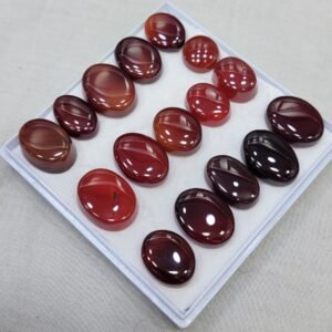 Authentic Natural Carnelian Agate (Aqeeq) from Yemen, featuring rich red to brown tones. Smooth oval cabochon cuts with beautiful natural banding, offered as a 16-piece stock lot for collectors and jewelry makers.