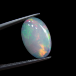 High-grade 3.37 carat natural Ethiopian Welo opal gemstone, featuring a vibrant multi-color "play-of-color" with neon green, orange, and red flashes.