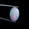 High-grade 3.37 carat natural Ethiopian Welo opal gemstone, featuring a vibrant multi-color "play-of-color" with neon green, orange, and red flashes.