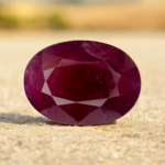 This is a Natural Ruby (Yaqoot) sourced from Mozambique, known worldwide for producing high-quality rubies with rich color saturation. The gemstone weighs 6.15 carats and features an elegant oval faceted cut that enhances its depth and brilliance. The stone exhibits a deep reddish to purplish-red hue with visible natural inclusions, confirming its natural origin. Ideal for high-end rings, pendants, or as a collector’s gemstone.