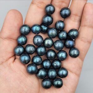 High-luster round dark blue pearl beads, featuring rare natural navy to midnight blue tones, perfect for luxury jewelry making and collector strands.