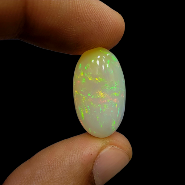 Magnificent 17.33 carat natural Ethiopian Welo opal featuring a vibrant "Neon Fire" play-of-color and a unique, naturally formed hole or hollow, showcasing its authentic volcanic origin.