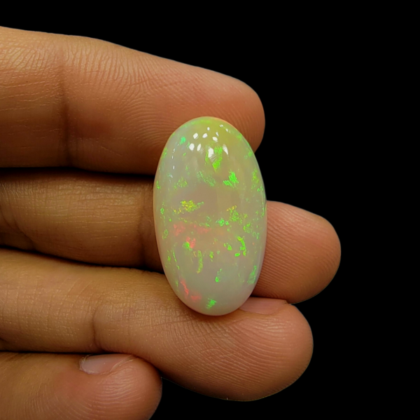 Magnificent 17.33 carat natural Ethiopian Welo opal featuring a vibrant "Neon Fire" play-of-color and a unique, naturally formed hole or hollow, showcasing its authentic volcanic origin.