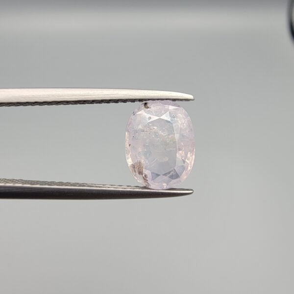 Certified 2.55 carat natural unheated sapphire from Sri Lanka (Ceylon), featuring a high-clarity crystal structure and vibrant natural color, shown in a professional gemstone display.