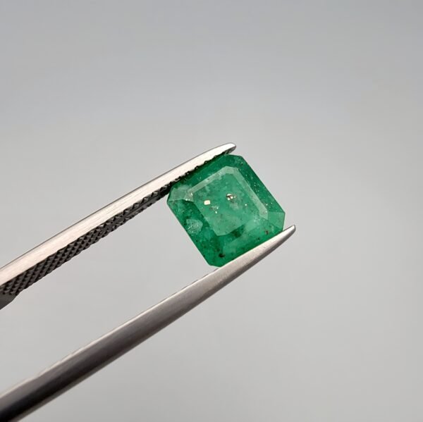 Vibrant 2.07 carat natural green emerald (Zamrud) from the Swat Valley, Pakistan, featuring a classic emerald cut with visible natural inclusions on the surface.