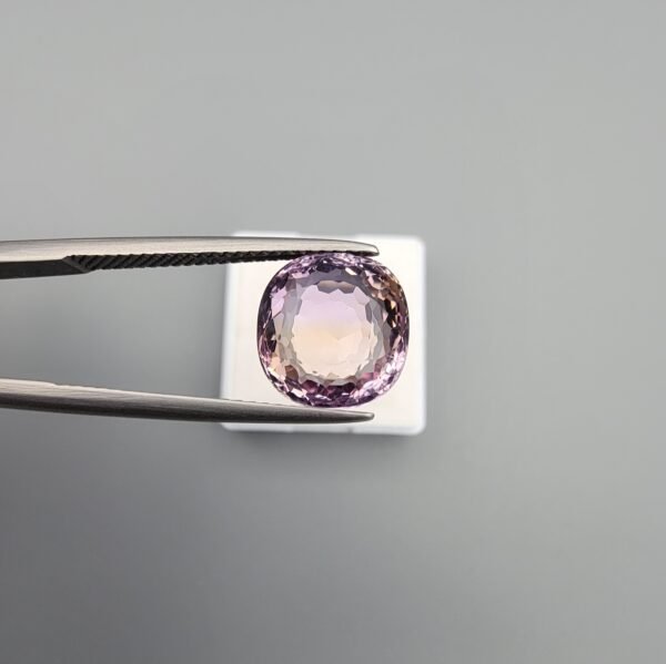 High-clarity 4.55 carat natural ametrine gemstone from Brazil, featuring a clear color split between violet amethyst and golden citrine in a precision-faceted round brilliant cut.