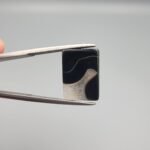 High-polished 5.22 carat natural Black Agate (Sulemani Aqeeq) rectangular cabochon featuring a crisp white parallel "banded" or "stratified" formation across a deep black background.