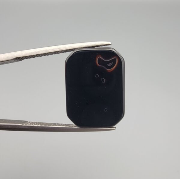 High-polished 7.17 carat natural Black Agate (Sulemani Aqeeq) rectangular cabochon featuring a unique natural white "bunny ears" formation on one side and a distinct "eye" formation on the reverse.