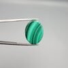 Large, high-polished 26.79 carat natural malachite (Dana-e-Farhang) gemstone featuring distinct forest green and emerald green banding in a smooth oval cabochon cut.