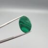 High-polished 17.81 carat natural malachite (Dana-e-Farhang) gemstone featuring swirling, multi-tonal green banding and orbital patterns in a smooth oval cabochon cut.