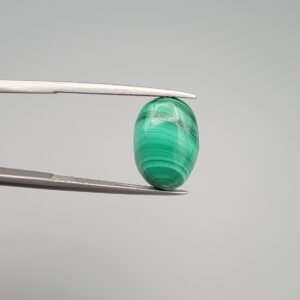 High-polished 8.02 carat natural malachite (Dana-e-Farhang) gemstone featuring fine, horizontal emerald green banding in a smooth oval cabochon cut.