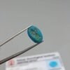 GGI certified 9.03 carat natural Arizona turquoise (Feroza) featuring a vibrant sky-blue color and a perfectly polished oval cabochon cut.