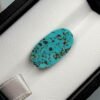 High-luster 3.50 carat natural Egyptian turquoise (Feroza) oval cabochon with a bright teal-blue body and a distinct, scattered dark brown matrix.