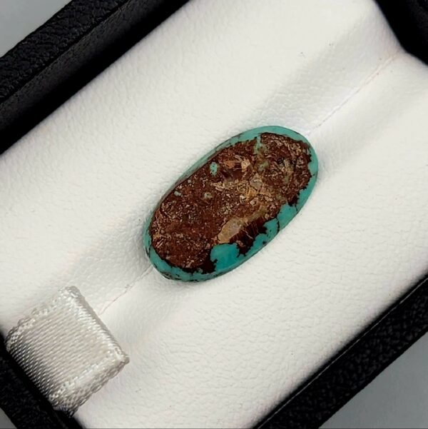 High-luster 3.50 carat natural Egyptian turquoise (Feroza) oval cabochon with a bright teal-blue body and a distinct, scattered dark brown matrix.