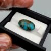Significant 15.29 carat natural Egyptian turquoise (Feroza) oval cabochon with a rich teal-blue body and an extensive, earthy brown spiderweb matrix.