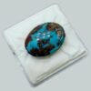 Massive 34.93 carat natural Egyptian turquoise (Feroza) oval cabochon featuring a vibrant teal-blue body with an extensive, high-contrast dark brown spiderweb matrix.