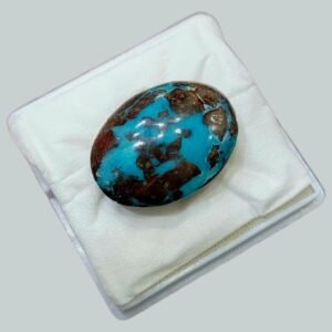 Massive 34.93 carat natural Egyptian turquoise (Feroza) oval cabochon featuring a vibrant teal-blue body with an extensive, high-contrast dark brown spiderweb matrix.