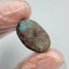 Large 12.70 carat natural Egyptian turquoise (Feroza) oval cabochon with a rich teal-blue body and an intricate dark chocolate-brown spiderweb matrix, presented in a black jeweler's display box.