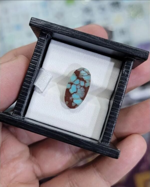 High-contrast 4.09 carat natural Egyptian turquoise (Feroza) oval cabochon featuring sky-blue "islands" within a rich, reddish-brown iron stone matrix.