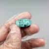 Large 19.65 carat natural Egyptian turquoise (Feroza) oval cabochon featuring a bright robin's egg blue body with a fine, scattered dark black-brown speckled matrix.