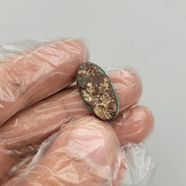 Vibrant 5.80 carat natural Egyptian turquoise (Feroza) elongated oval cabochon with a bright teal-blue body and large, concentrated dark brown iron-rich matrix "islands".