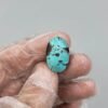 Significant 18.03 carat natural Egyptian turquoise (Feroza) oval cabochon featuring a vibrant sky-blue body with large, bold dark brown matrix "island" clusters.
