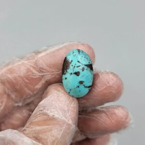 Significant 18.03 carat natural Egyptian turquoise (Feroza) oval cabochon featuring a vibrant sky-blue body with large, bold dark brown matrix "island" clusters.