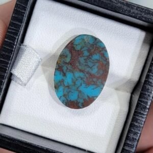 High-quality 7.42 carat natural Egyptian turquoise (Feroza) oval cabochon with a vivid sky-blue body and a dense, reddish-brown iron stone spiderweb matrix.
