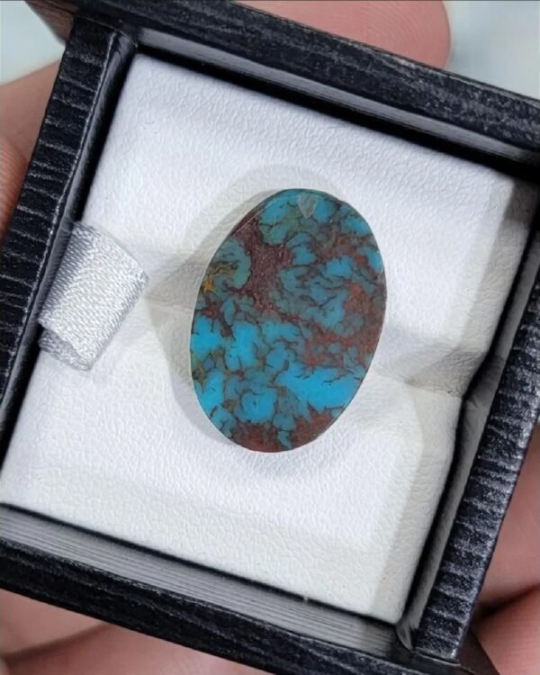 High-quality 7.42 carat natural Egyptian turquoise (Feroza) oval cabochon with a vivid sky-blue body and a dense, reddish-brown iron stone spiderweb matrix.
