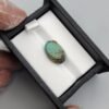 Vibrant 7.04 carat natural Egyptian turquoise (Feroza) oval cabochon displaying a luminous sky-blue surface with a delicate, fine dark-brown spiderweb matrix.